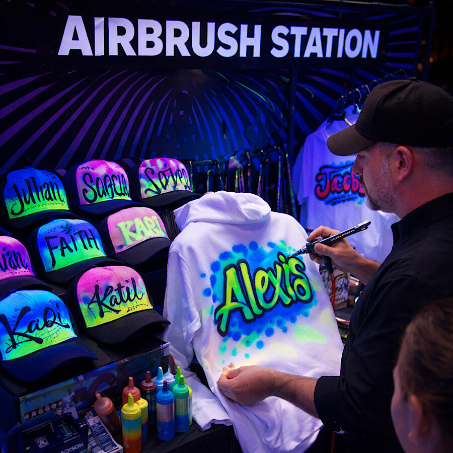 AirBrush Station - A live custom art experience where guests watch their names and designs come to life on hoodies ,hats ,and tees .Bold ,colorful ,and completely personalized - the ultimate party favor they'll acually want to keep .